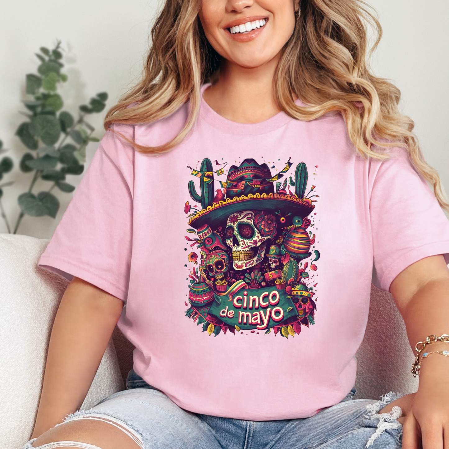 Graphic Unisex Vintage shirt that reads &quot;Cinco De Mayo&quot; and features day of the day decorated skulls on Bella and Canvas shirt in the color light pink