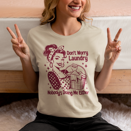 Add a touch of humor to your wardrobe with this Don't Worry Laundry Nobody's Doing Me Either sarcastic t-shirt. Made from soft and breathable fabric, this stylish tee is perfect for everyday wear. Let your outfit speak for itself with this cheeky and relatable statement piece. Whether you're running errands or lounging at home, this t-shirt is sure to bring a smile to your face. Stand out from the crowd and show off your