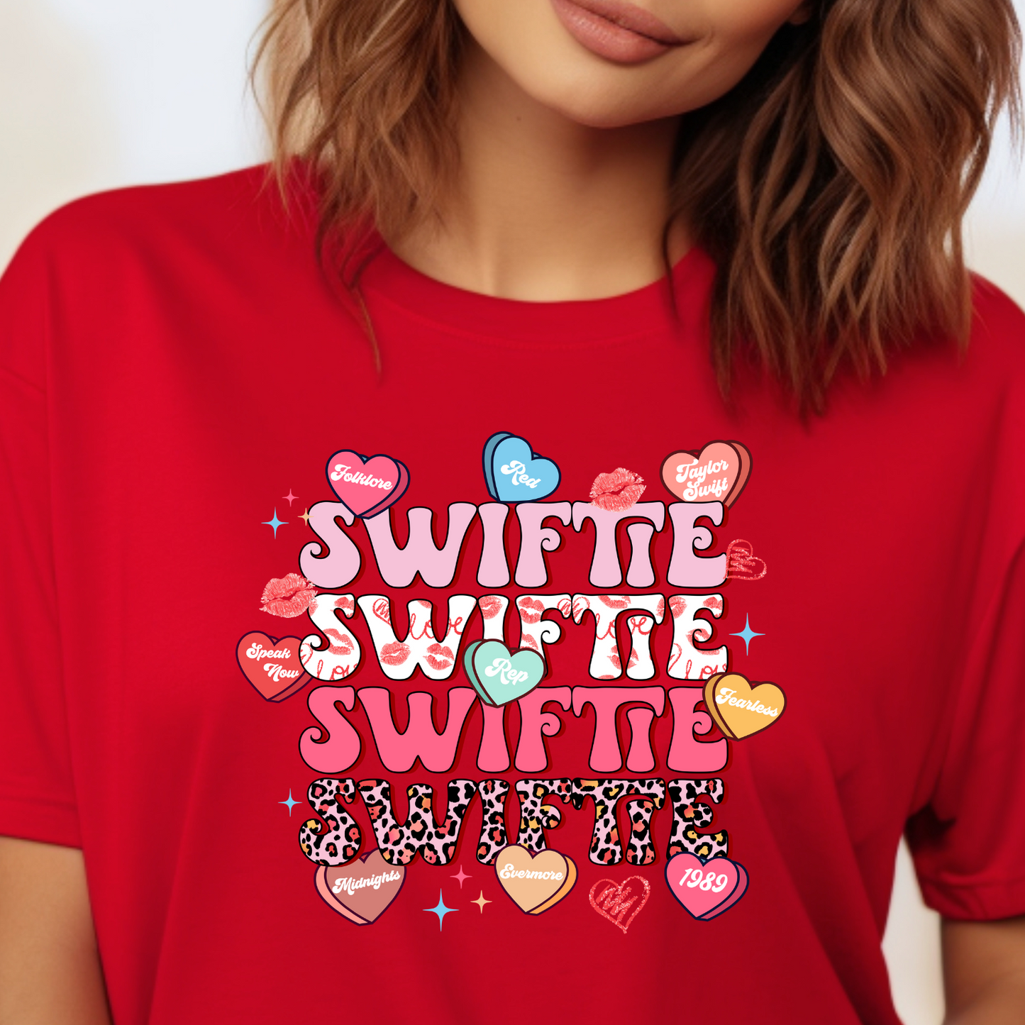 Show your Swiftie devotion with our catchy Taylor Swift-inspired shirt! Featuring her iconic record names on candy hearts, this shirt is a must-have for any die-hard fan. Elevate your style with a touch of Taylor Swift nostalgia and wear your love for her music proudly. Get ready to express your fandom in style with this must-have shirt!