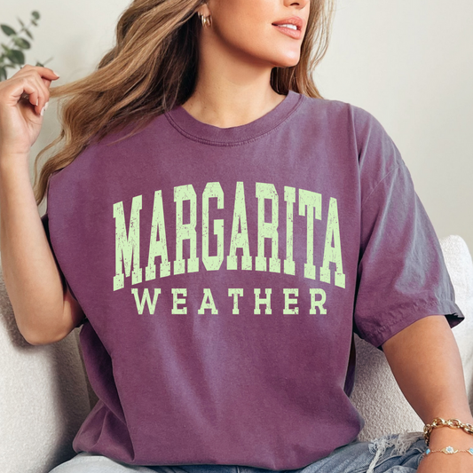 This vintage Margarita Weather t-shirt is the perfect addition to your summer wardrobe! Made from soft and breathable fabric, this retro-inspired tee features a fun and playful design that is sure to make a statement. Whether you're enjoying a beach day or sipping margaritas with friends, this t-shirt is the ideal choice for soaking up the sun in style. Add a touch of nostalgia to your outfit with this unique and charming piece. A must-have for any vintage lover or cocktail connoisseur!